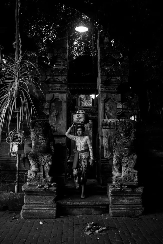 A Balinese woman at the entrance to a temple.